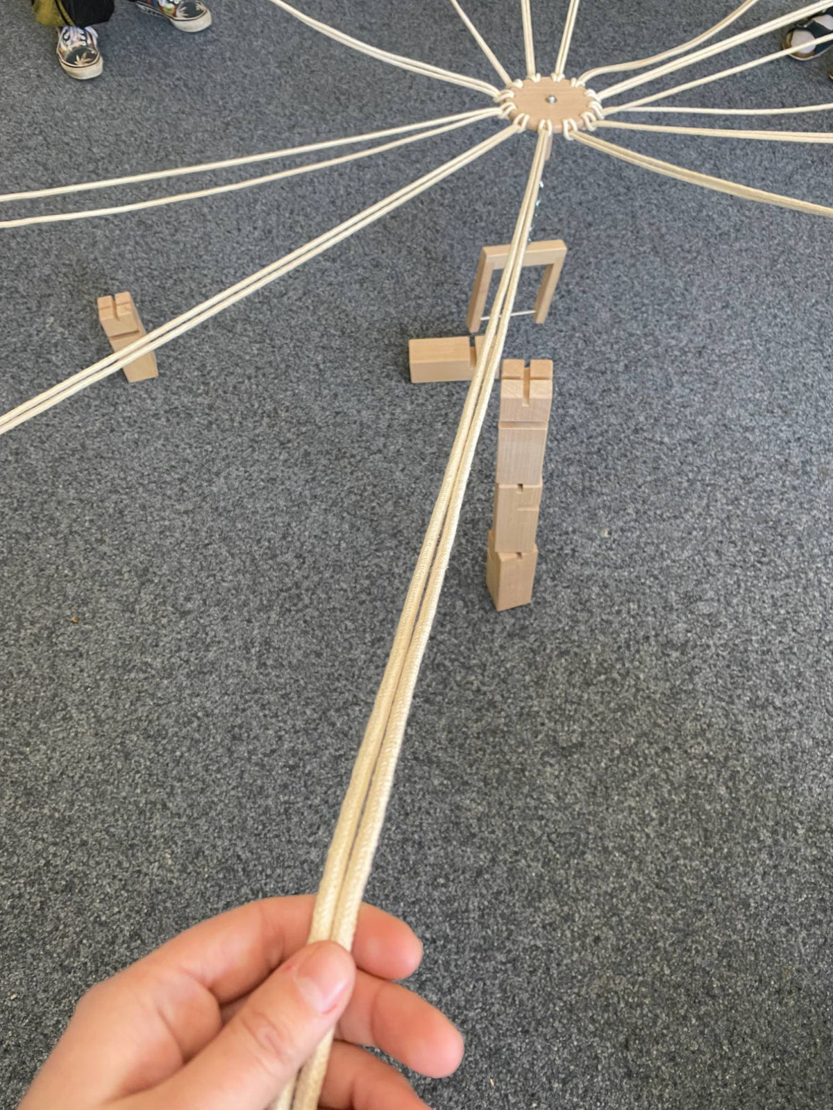 Fröbelturm im Spiel: Seile, Greifbügel und gestapelte Holzklötze von oben